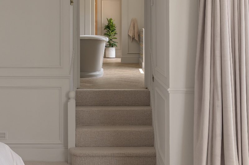 A view inside the bathroom from the calm, neutral bedroom.