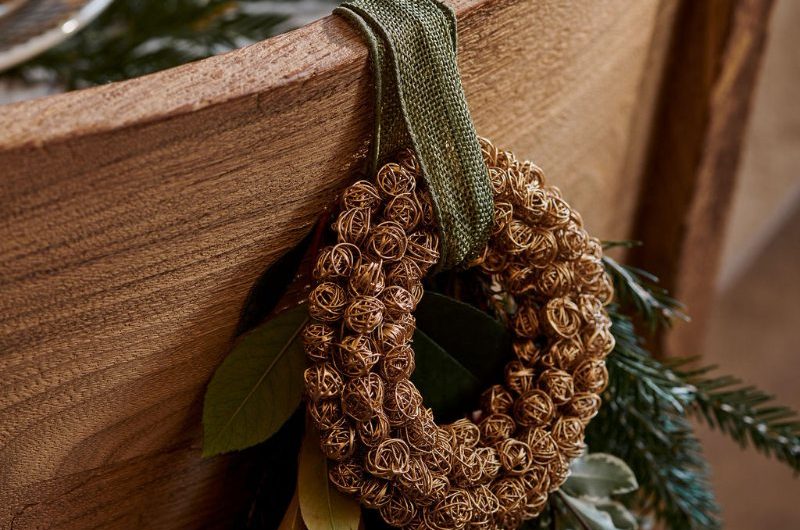 Closeup at a chair with festive decorations hanging from the backrest.
