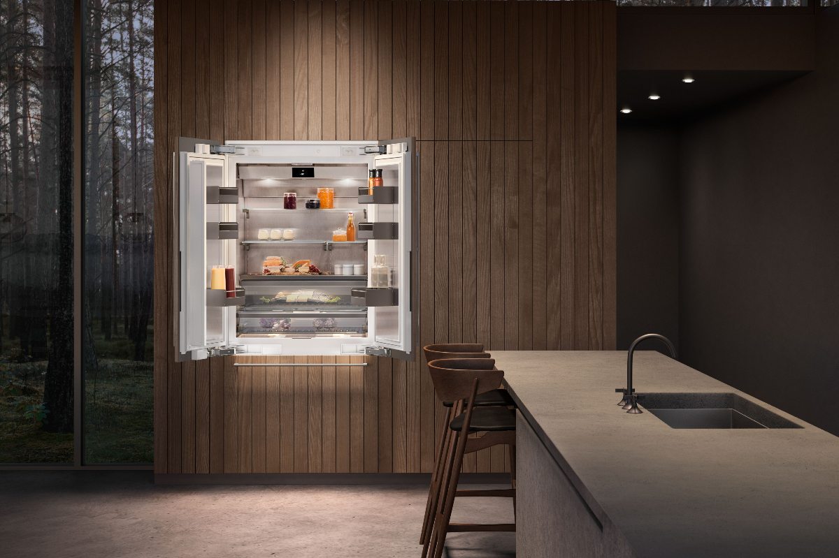 Scandi style kitchen with wood panelling, an integrated fridge and a central island with seating and a sink and tap.
