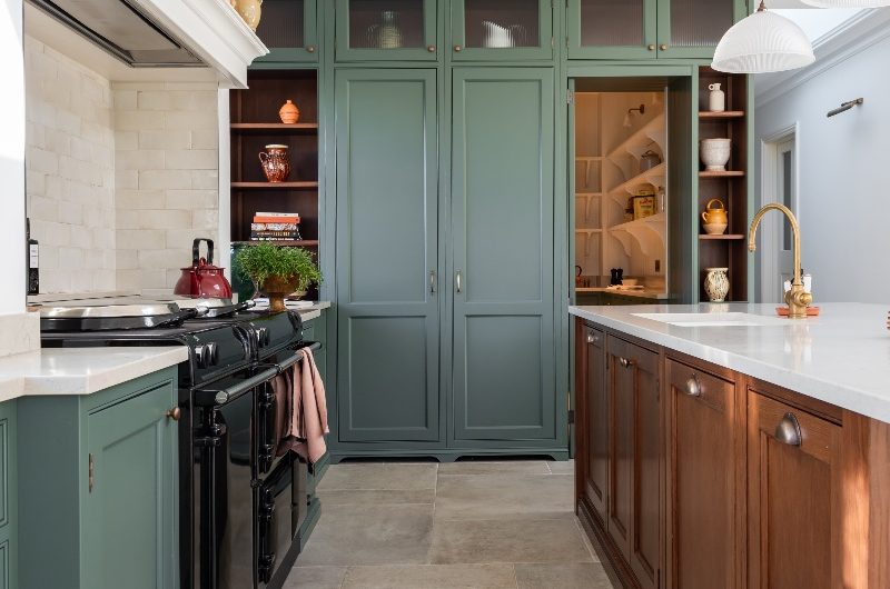 View of the cabinetry layout with classic doors, aged brassware, and a hidden walk-in pantry.
