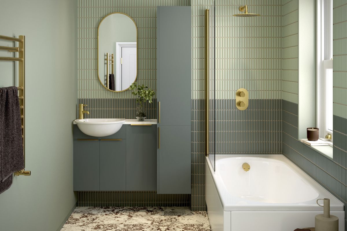 A bathroom drenched in green shades with kitkat tiles on the wall, a fitted tub with a shower panel and brassware, and a customisable vanity unit.