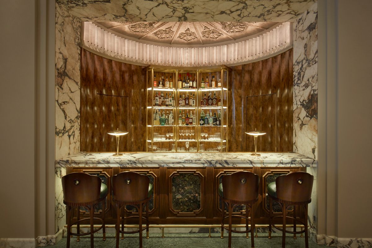 Claridge's opulent bar with statement marble, and decorative ceiling.