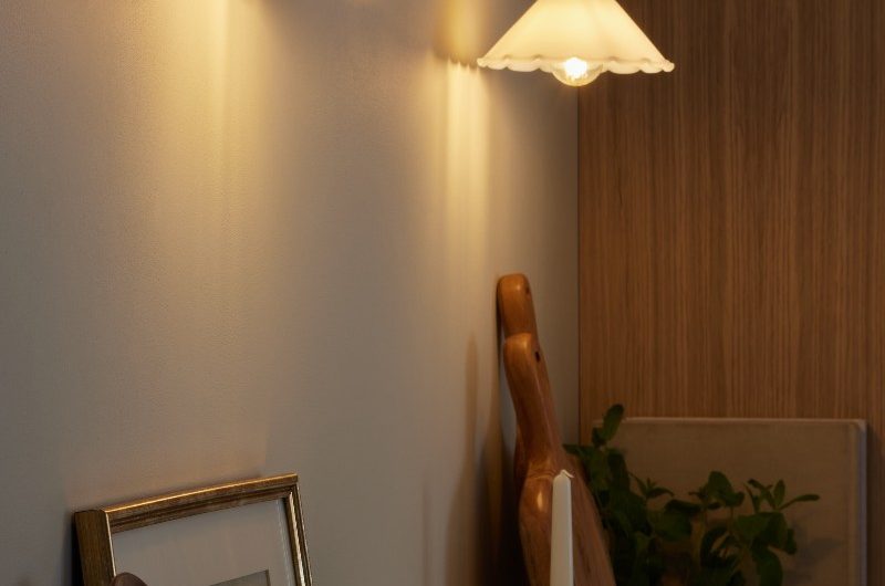 A rustic design with photo frames, wood trays, and ceramics on the countertop to two wall lights diffusing a soft glow.