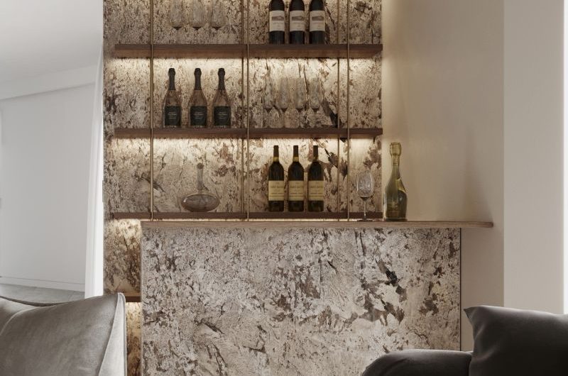 A luxurious drinks zone with statement stone wall cladding and peninsula, LED lighting and wood shelves.