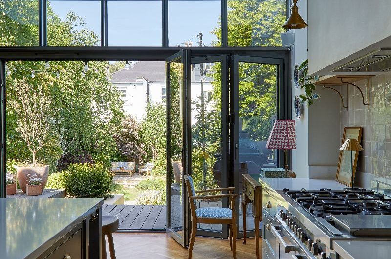 A look into the garden from the warm kitchen with parquet herringbone flooring.