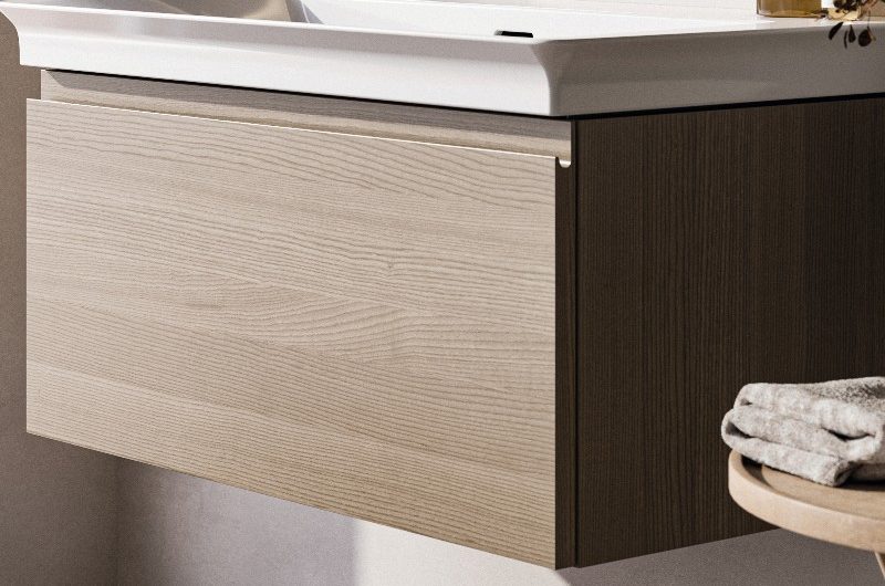 A quiet bathroom with a wood vanity, inset basin, and chrome taps.
