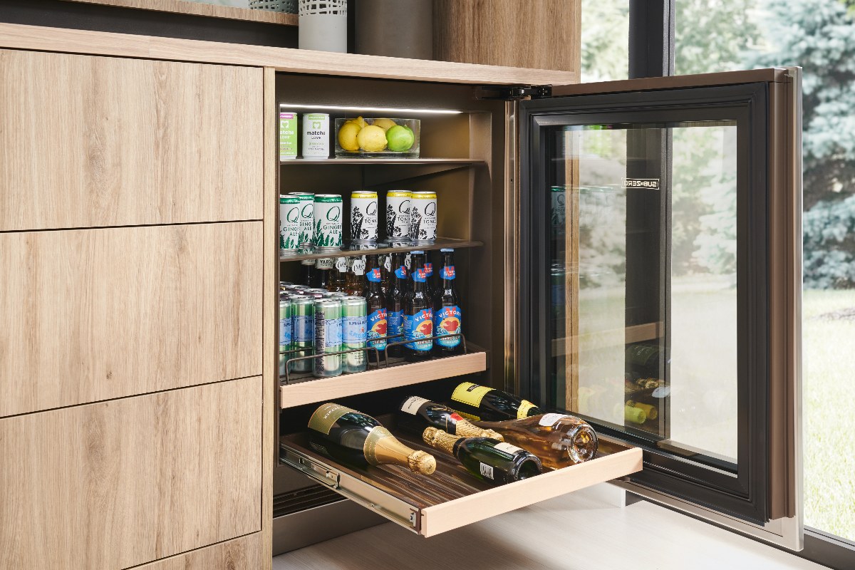 A wood kitchen design with a fridge cabinet.