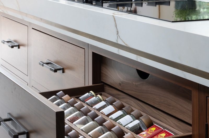 An island design with bespoke drawers for spices.