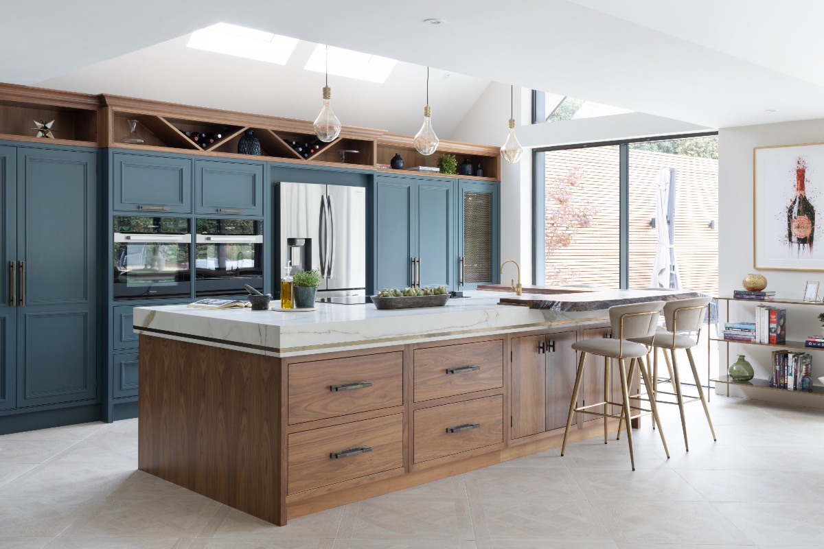 A sophisticated contemporary kitchen with dark blue cabinetry, and a central multi-functional wood island.
