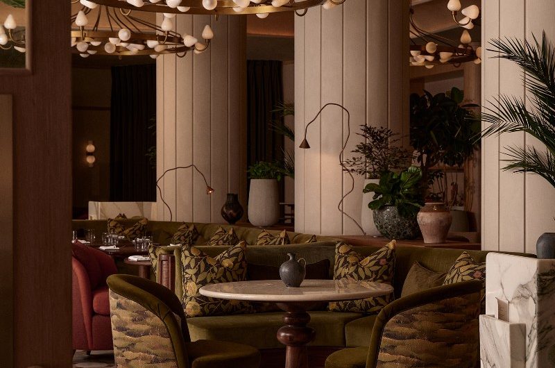 A characterful hotel with a restaurant with biophilic patterns and elegant lighting.