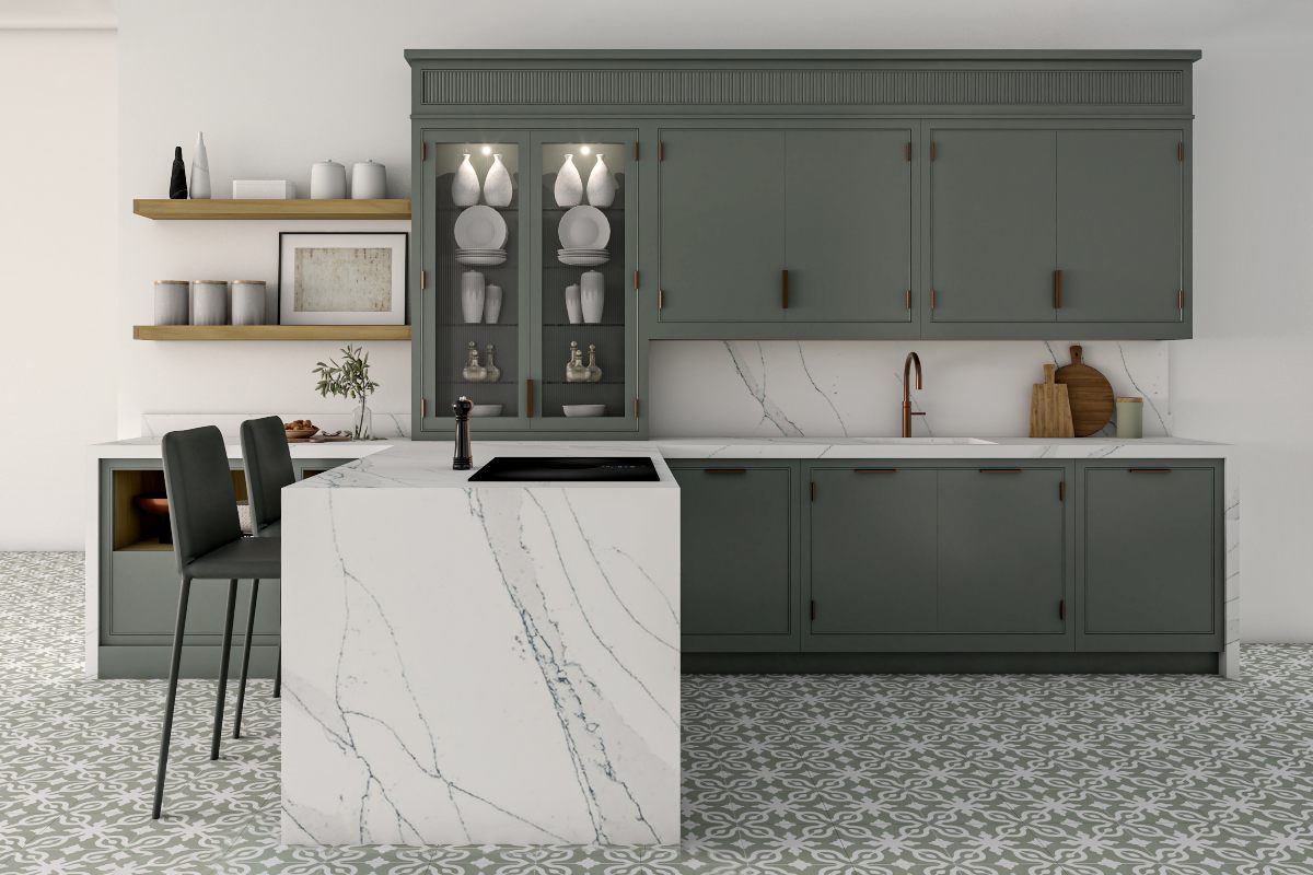 A green kitchen design with micro Shaker cabinets, a stone peninsula, and patterned flooring.