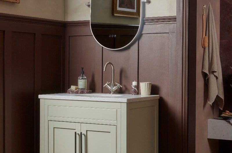 A timeless bathroom design with terracotta flooring, a neutral vanity, dark red-brown wall panelling, and a shower zone.
