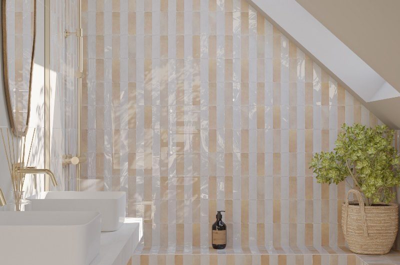 A wellness-inspired showering space with striped tiles, double basins, and a bath.