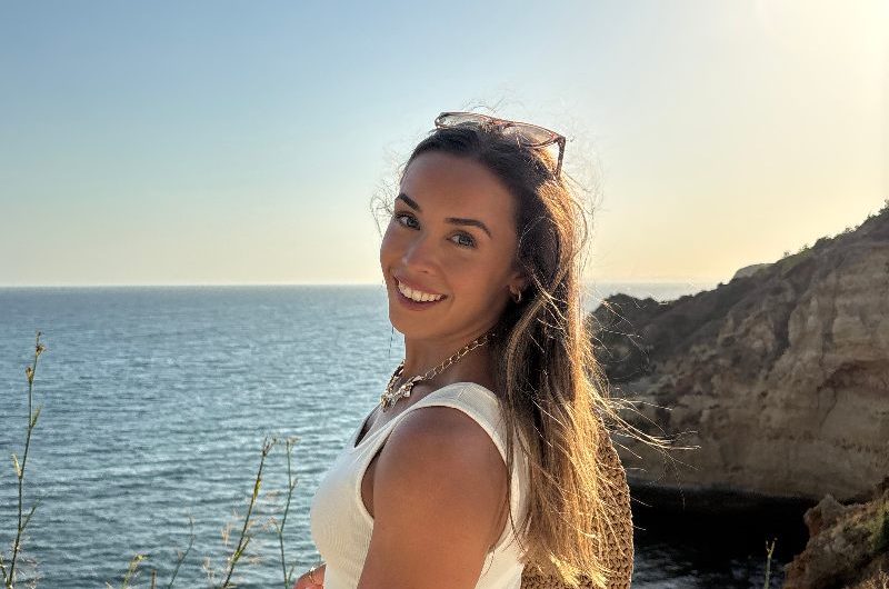 Homeowner posing by the sea.