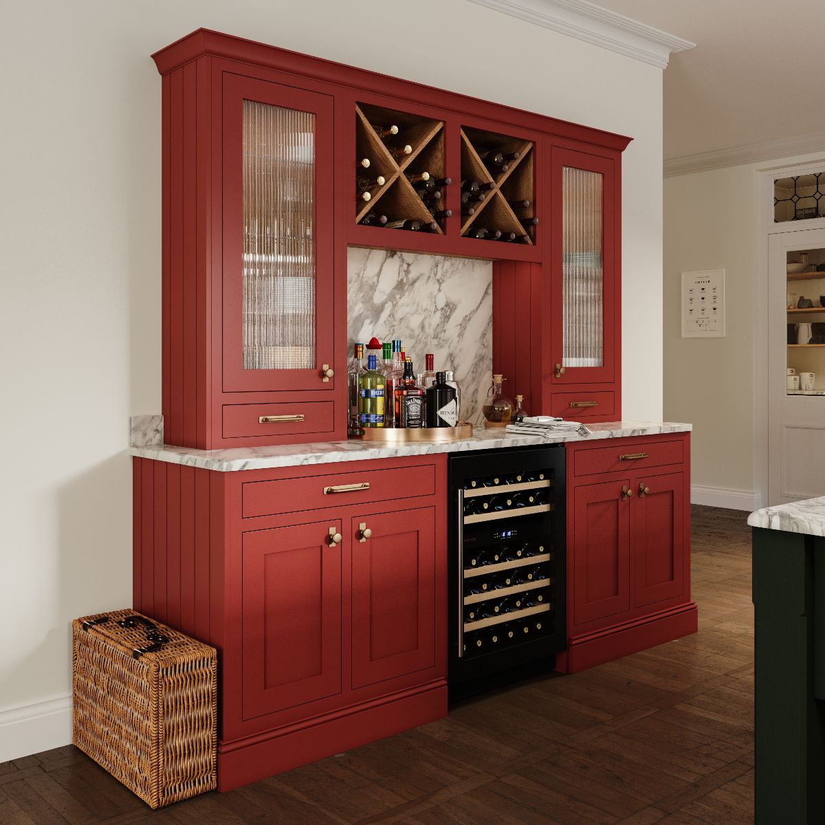 A dark red drinks station with a wine fridge, bottle storage, marble worktop and splashback and fluted glass cabinets.