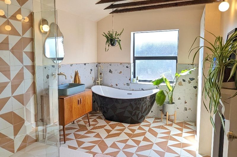 Bathroom renovation project with tiled floor and shower zone, with a freestanding tub, and terrazzo floor tiles.