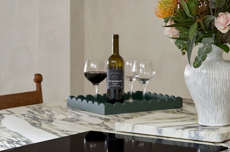 Closeup at the kitchen island with calacatta viola marble and an extractor hob.