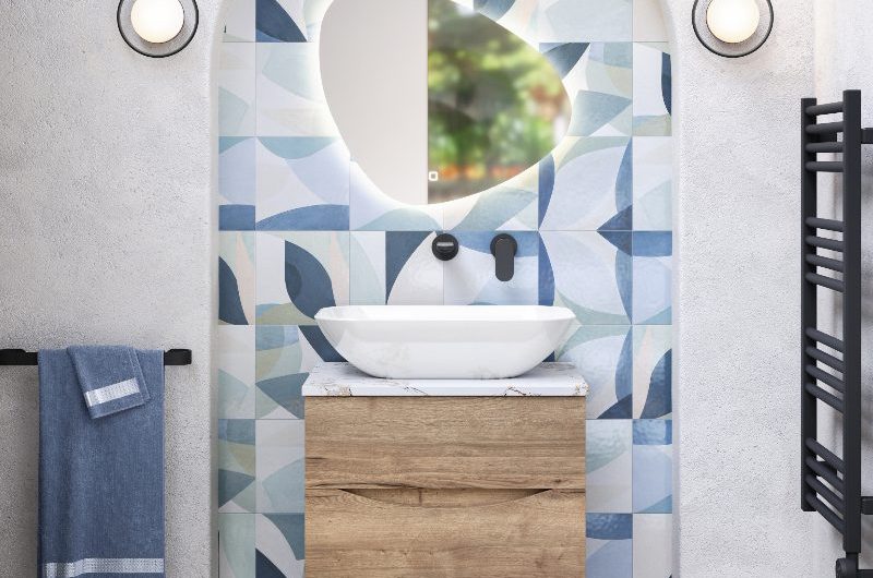 A modern vanity area in a tiled alcove, with a wall-mounted wood unit, with a countertop basin, concrete-effect wall and floor coverings.