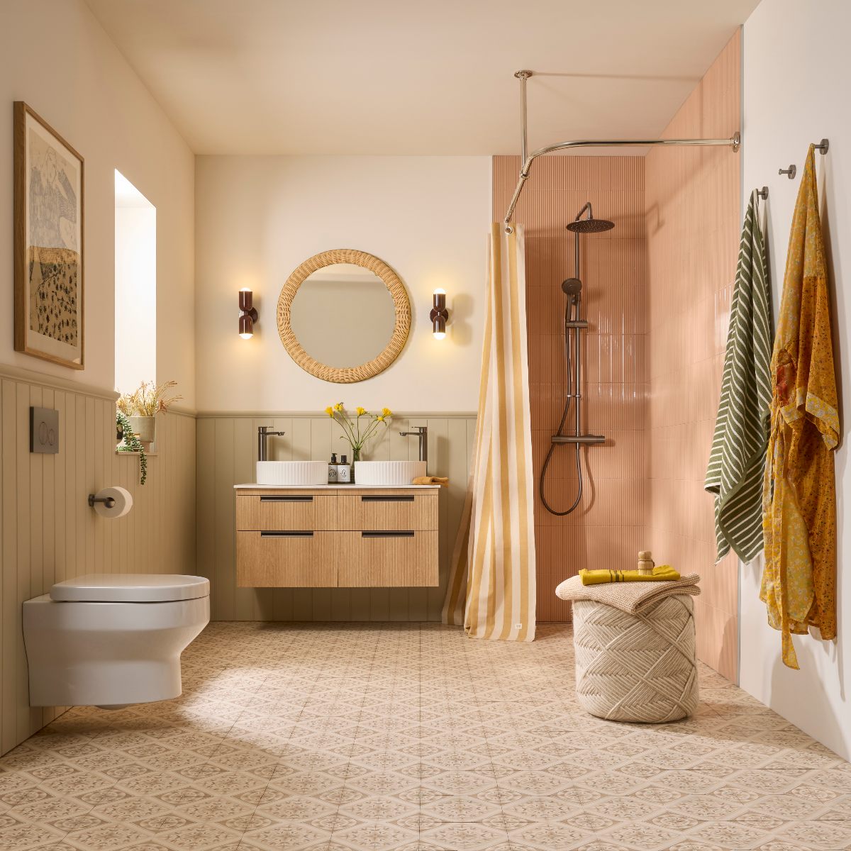 A spacious, light-filled bathroom with a double vanity, wall-mounted toilet, and a shower with a striped curtain, with peachy fluted tiles, and patterned flooring.