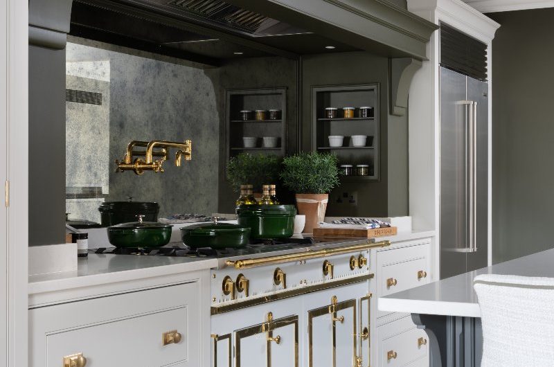 A timeless kitchen design with a statement cooking zone, with a range cooker, mirrored splashback and grand overmantel.