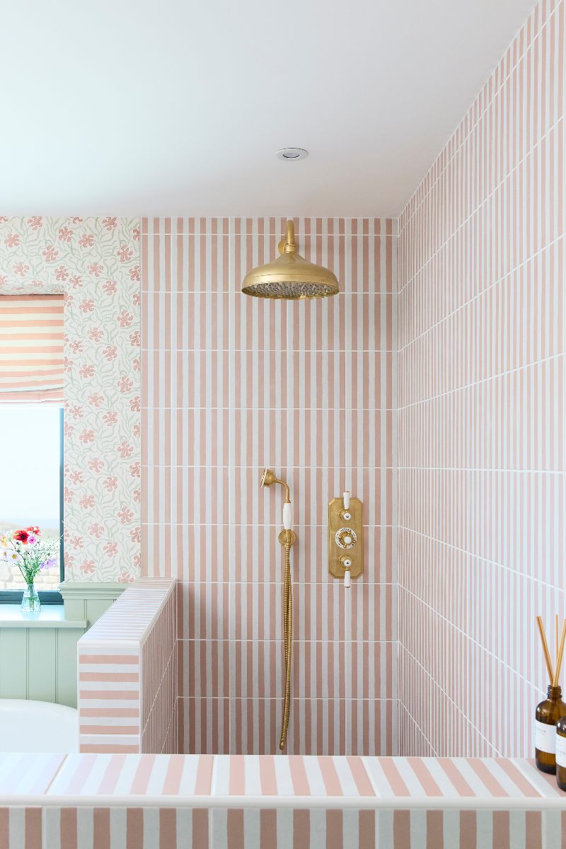A striped shower zone with traditional brassware.