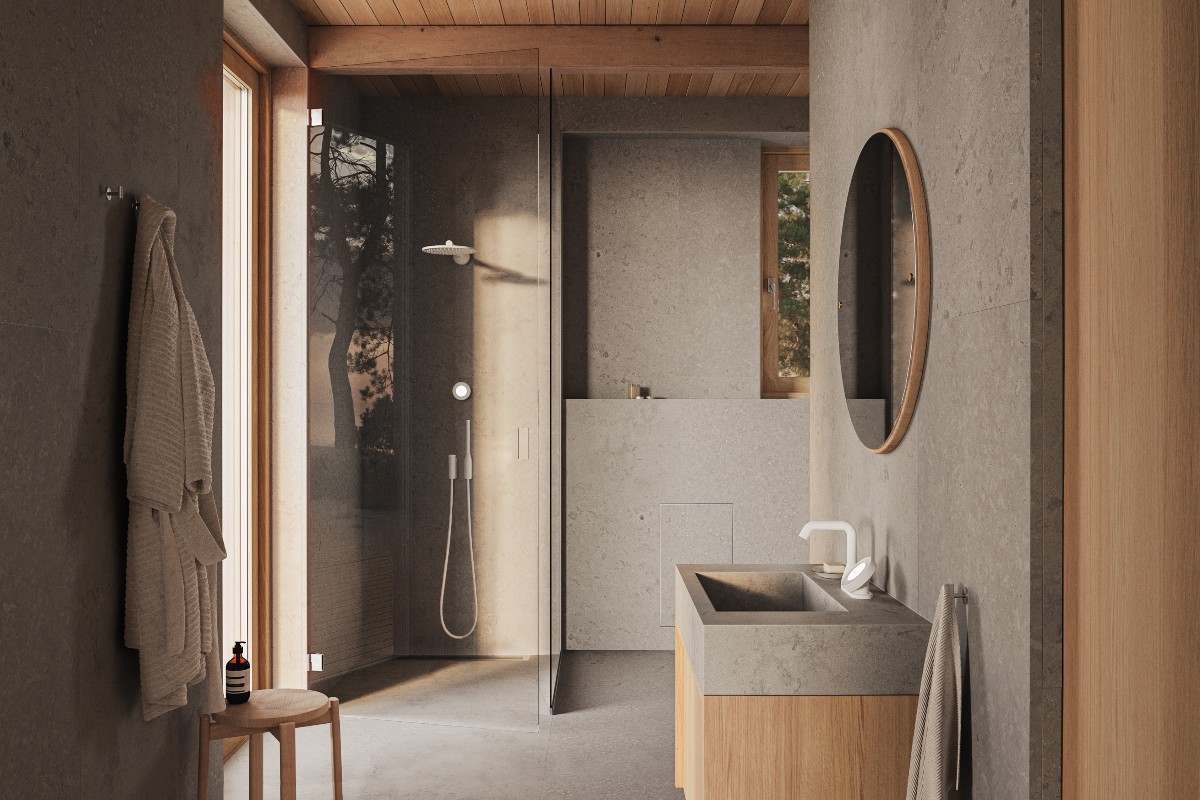 A minimalist, nature-inspired scheme with an eco-conscious shower system, a basin with a smart tap and wood vanity, drenched in concrete-effect wall and floor coverings.