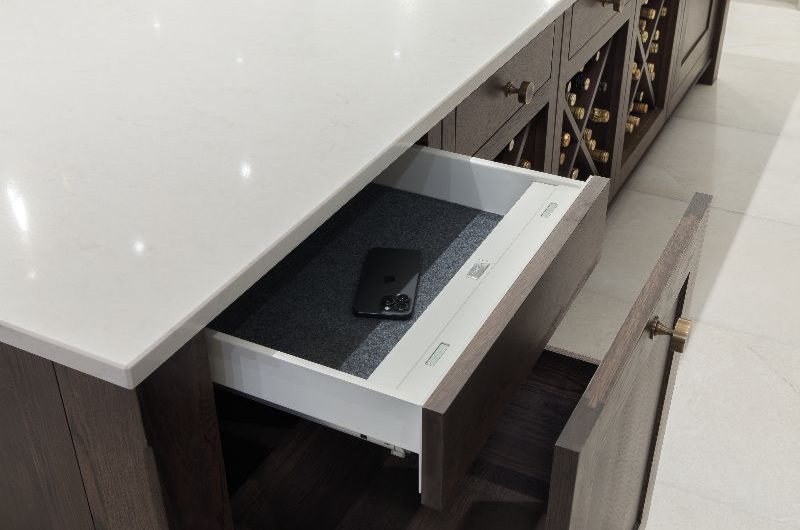 A wood kitchen island with a hidden safe within the cabinetry.