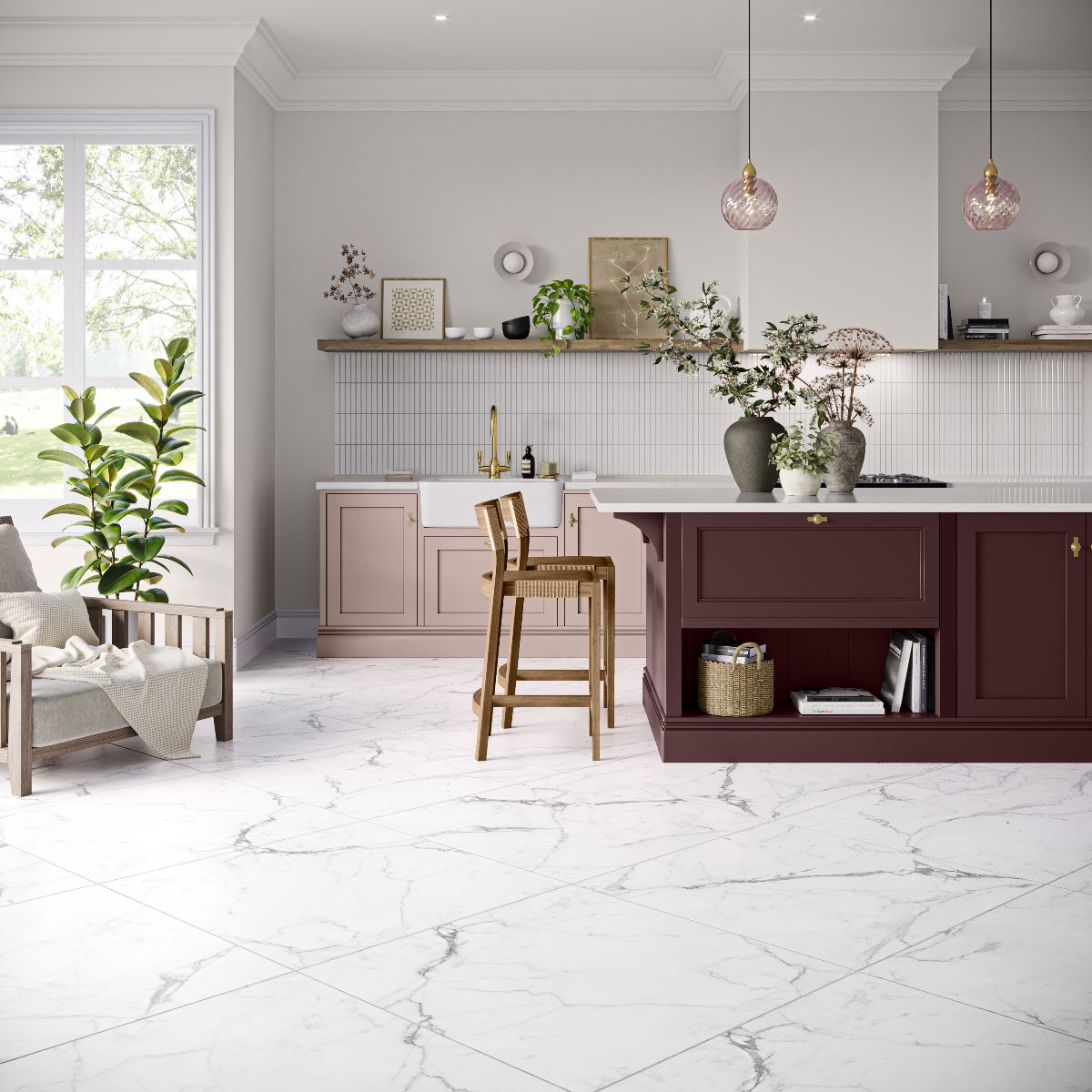 A timeless kitchen with pale pink base units, a burgundy island, and large-format marble-effect porcelain floor tiles.