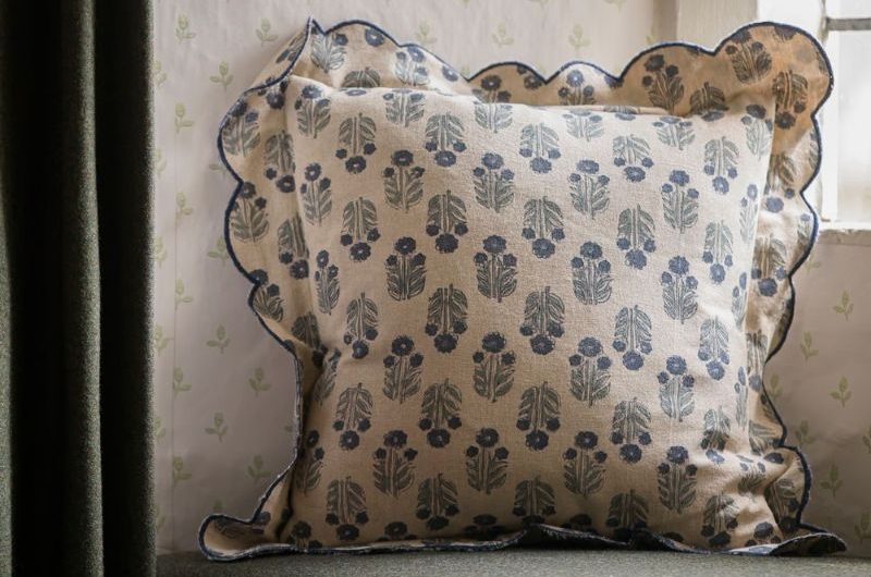 Closeup at a floral, frilled cushion, perfect for the Wuthering Heights aesthetic.