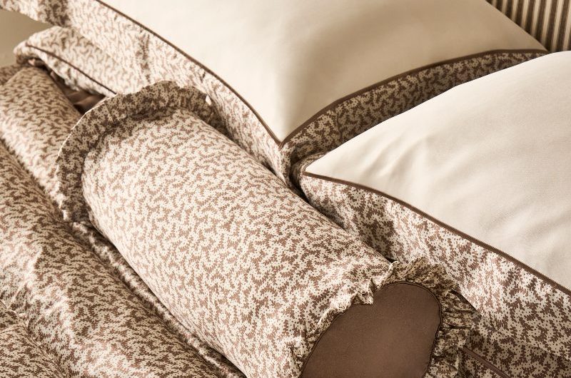Closeup at neutral patterned silk bed linen.