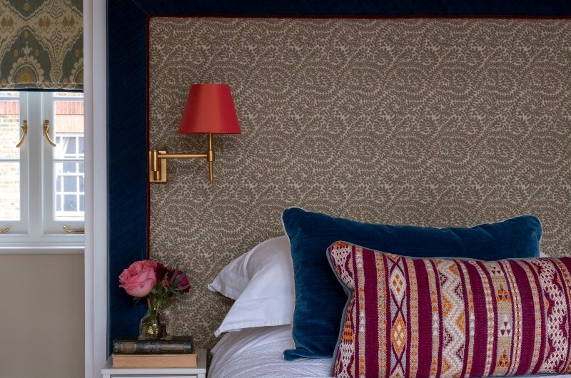 A luxurious bedroom scheme with a velvet border on the bespoke headboard and built-in lighting.