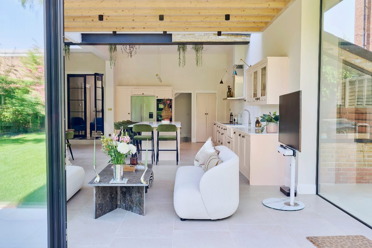 View inside the open-plan extension with a cooking zone, island for entertaining, and a seating area by the glazing.