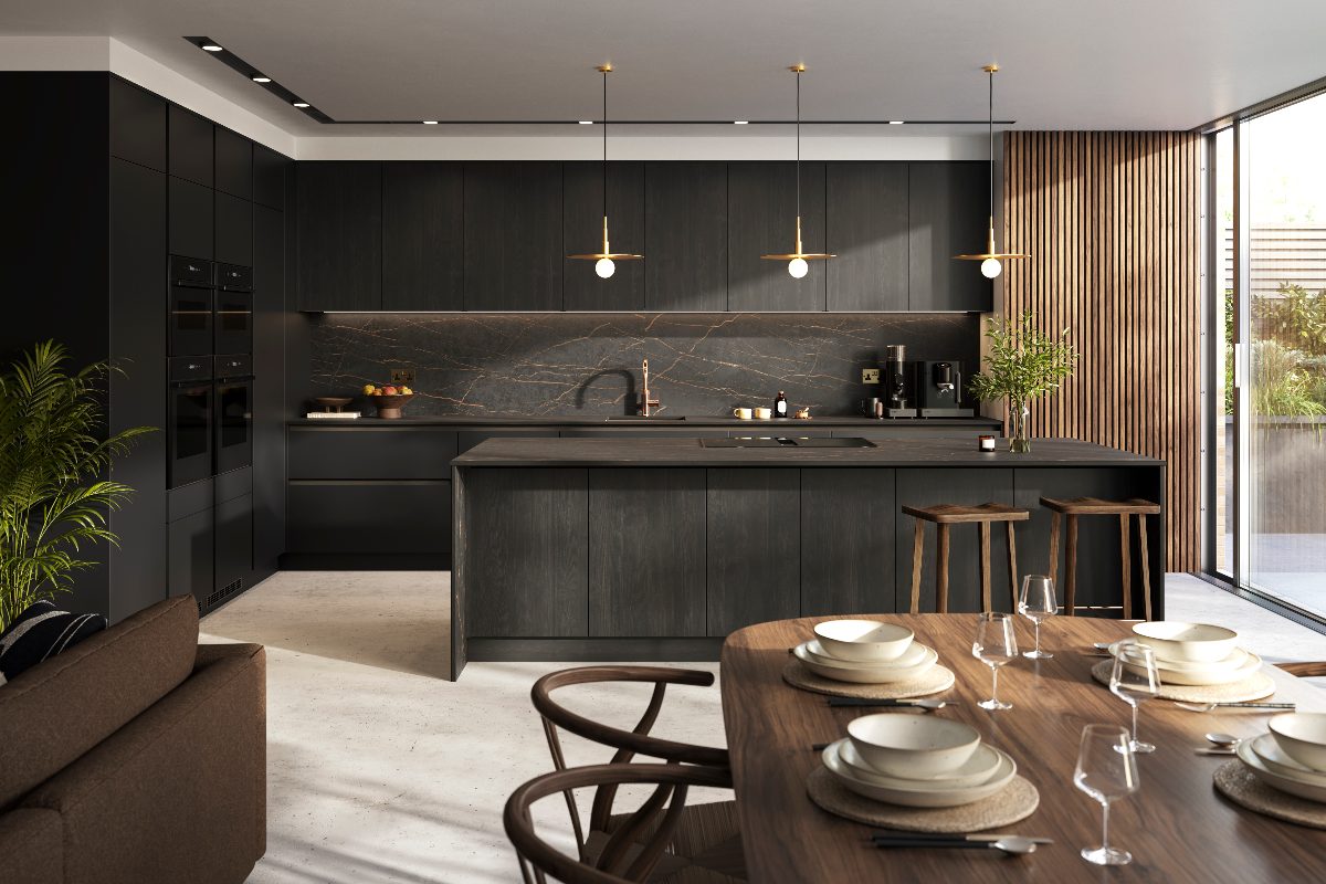 A dark kitchen design with handleless units, veiny surfaces, a central island, layered lighting, fluted wall panelling, and a dining zone near the bifold glazing.