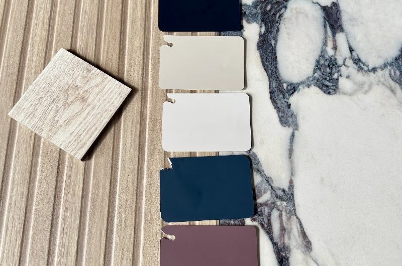 Moodboard of an ensuite design with wood and marble surfaces and moody colourways.