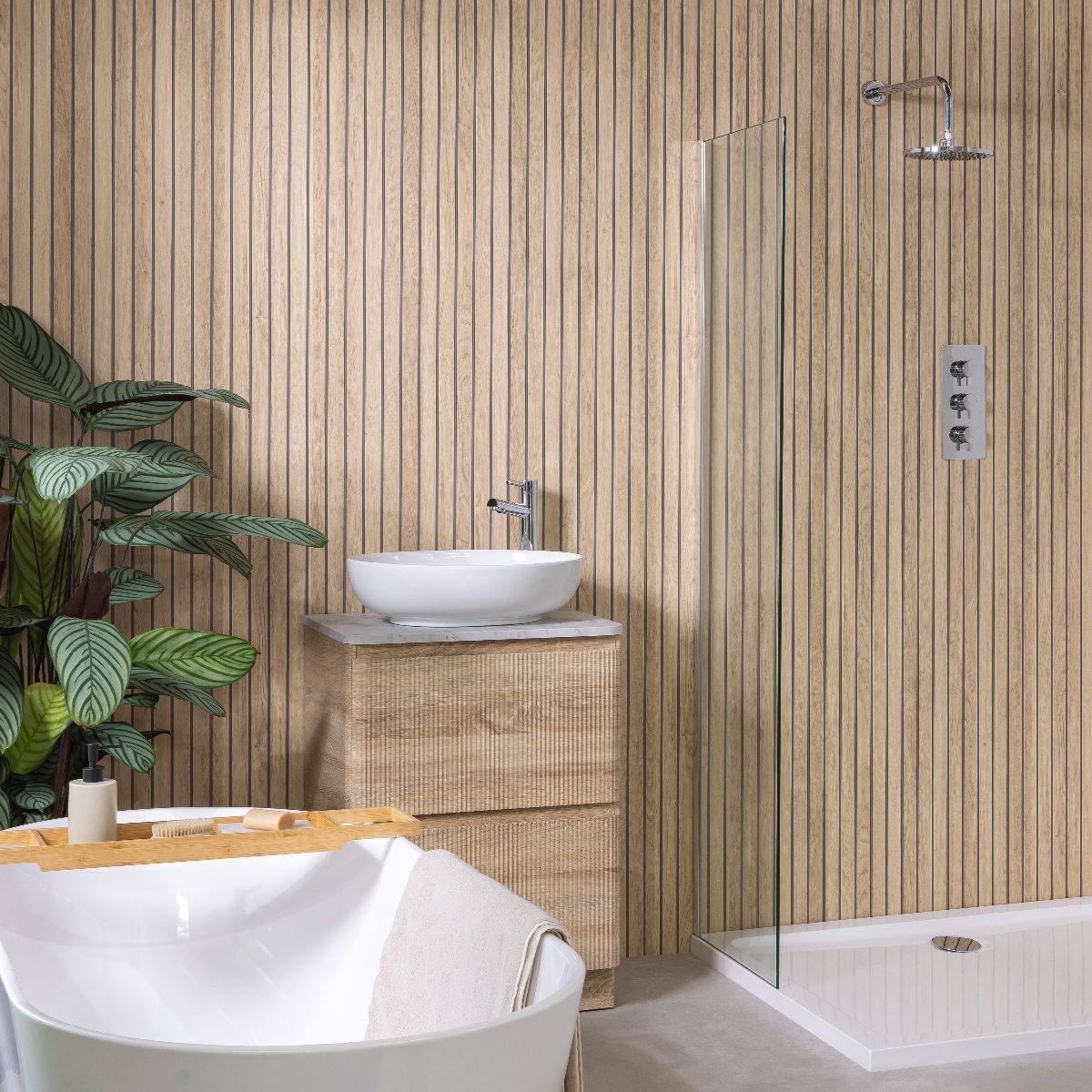 A wood clad bathroom with fluted panelling, fluted vanity, chrome brassware, and a freestanding tub.