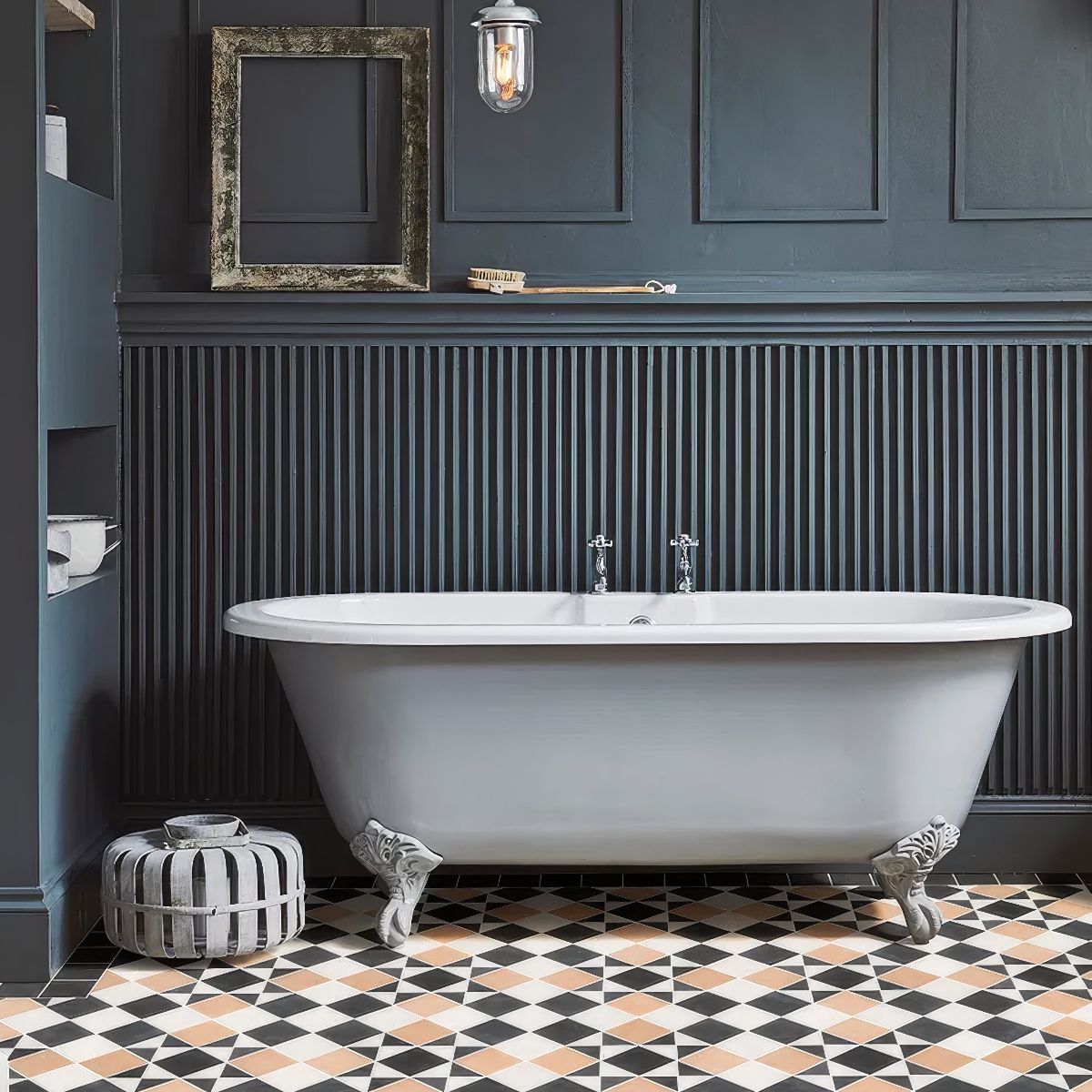 Wuthering Heights bathroom aesthetic with Victorian floor tiles, a classic freestanding tub, blue wall panelling, and aged decor.