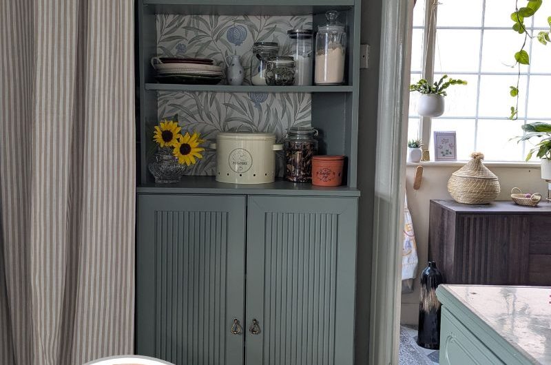 A DIY pantry with space wallpaper and moulding.