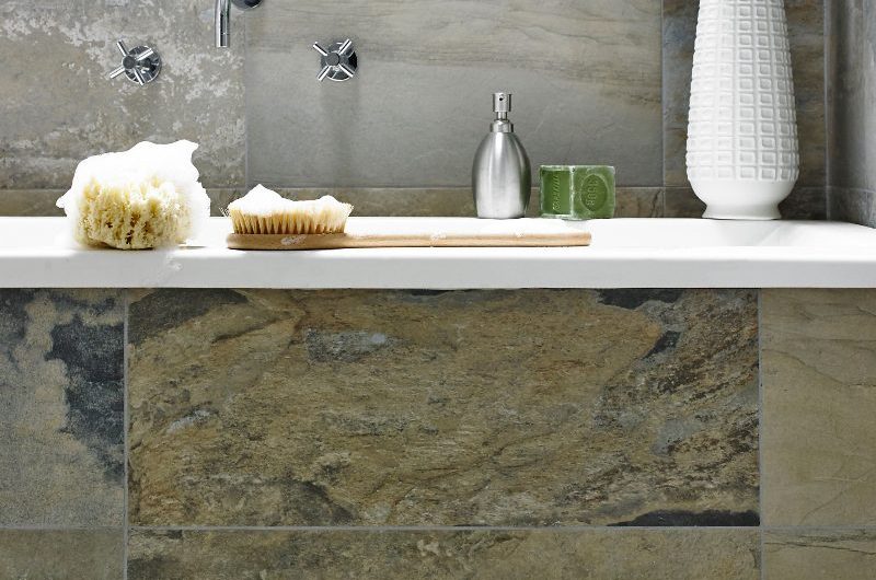 A spa-like bathroom with large-format tiles, a fitted tub, and chrome brassware.