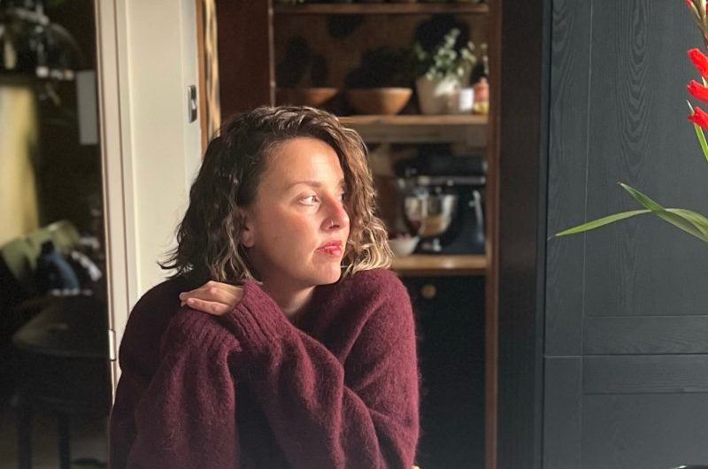 Homeowner posing at her kitchen island.