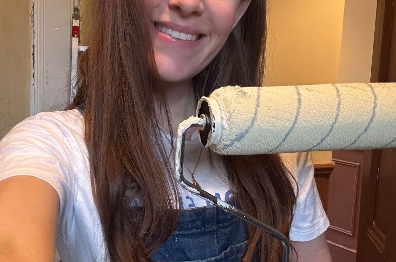 Headshot of a renovator with a painting roller brush.