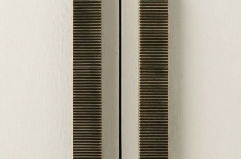 Closeup at bronze, reeded handles.