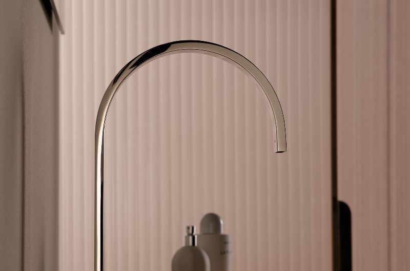 A luxurious bathroom design with a sleek tap with tactile mixers and an inset basin.