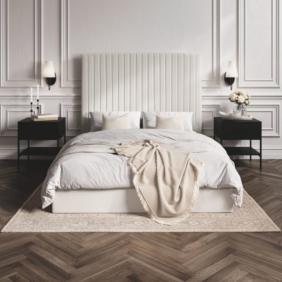 A classic bedroom with a tall white headboard, wood flooring, timeless panelling, and symmetric bedside zones.