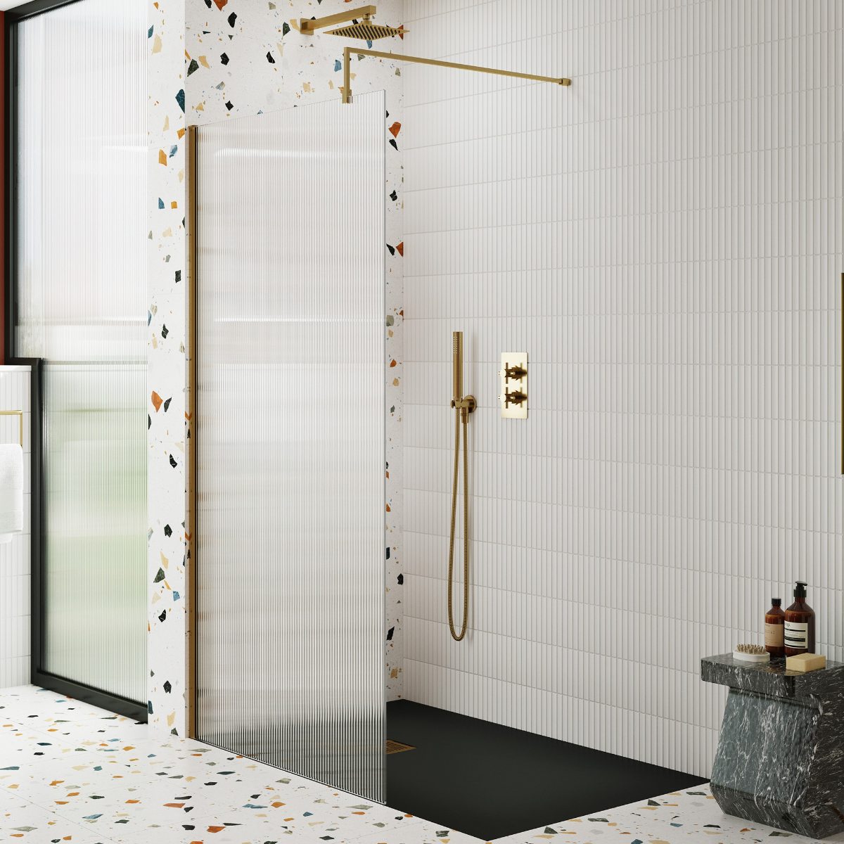 A minimalist bathroom with terrazzo surfaces, and a shower zone with fluted panel, dark shower tray and white kitkat wall tiles.
