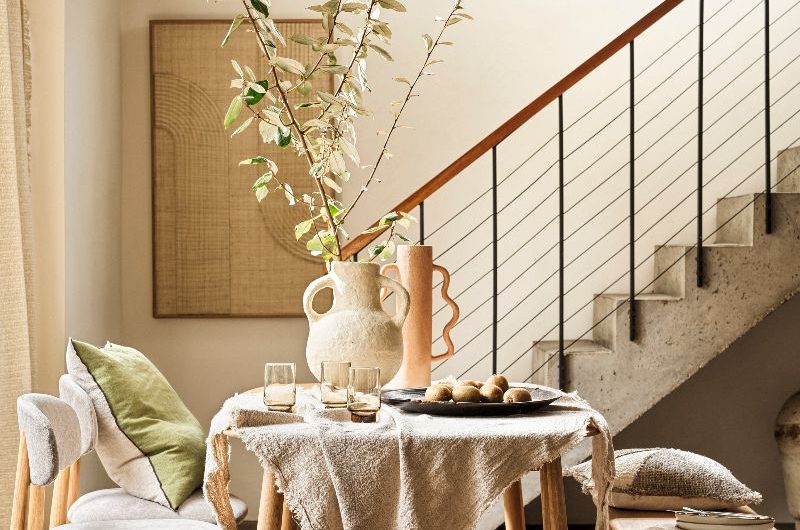 A rustic dining room with a table, chairs and bench.