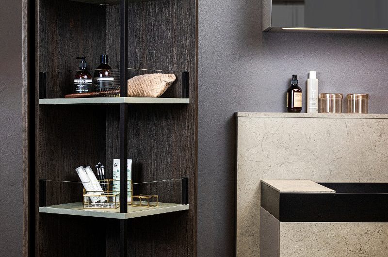 A modern bathroom with smart storage, a stone basin area, and mirror cabinet.