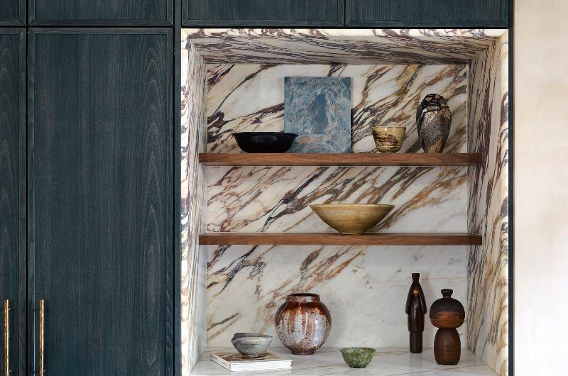 Closeup at a kitchen nook with calacatta viola marble, open shelving, and minimalist decor.