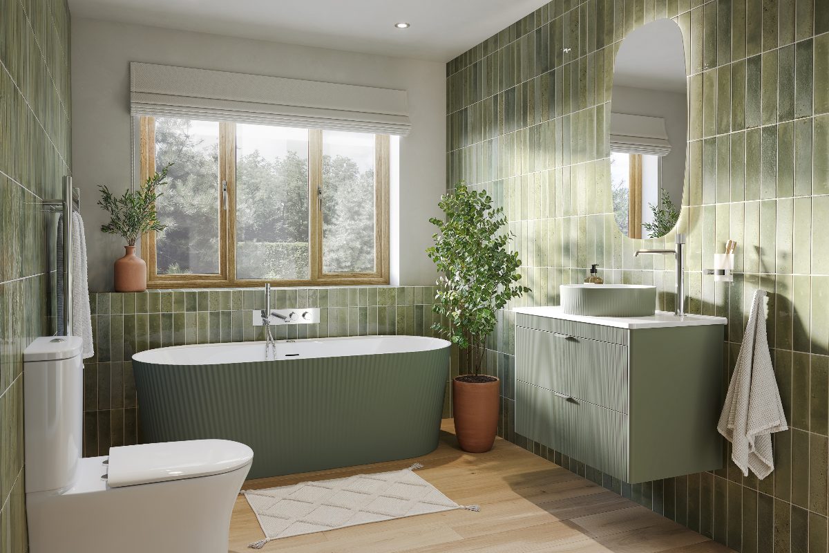 A colour drenched bathroom with green tiles, fluted bath, fluted vanity unit with a matching basin, and an LED mirror.