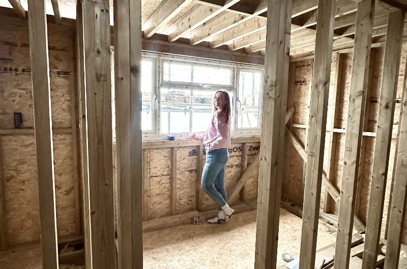 Homeowner admiring the new windows of her loft conversion.