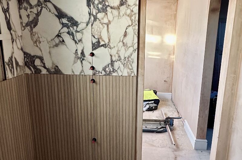 Ensuite building works with materials being applied to the walls.